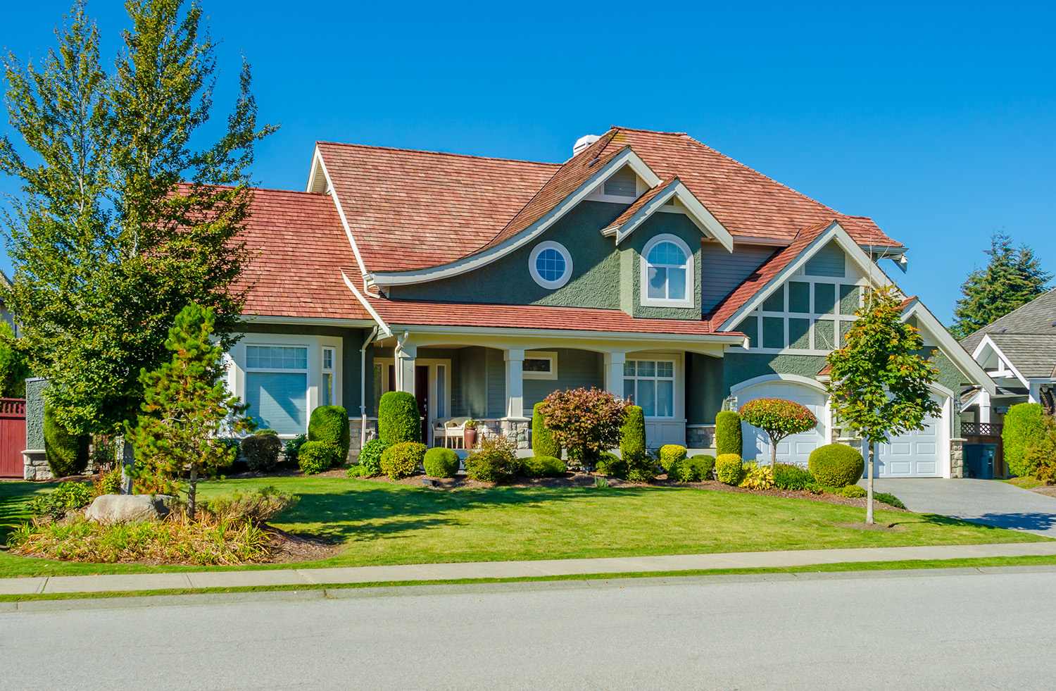 A beautiful two story house on the side of a road